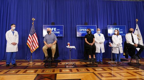 Vice President Mike Pence, seated left, his wife Karen Pence, seated center, and U.S. Surgeon General Jerome Adams, seated right prepare to receive a Pfizer-BioNTech COVID-19 vaccine shot at the Eisenhower Executive Office Building on the White House complex, Friday, Dec. 18, 2020, in Washington