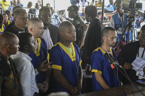 Three Americans accused of being involved in last month's coup attempt in Congo appeared in a military court in the country's capital, Kinshasa, on Friday, along with dozens of other defendants who were lined up on plastic chairs before the judge on the first day of the hearing.