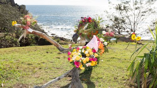 Floral tributes are seen at the Seventeen Seventy Headland, Gladstone, Queensland. (AAP)