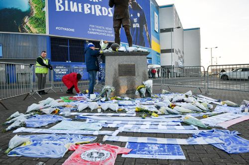 Flowers and tributes left by the statue of Cardiff City footballer Frederick Charles Keenor outside Cardiff City Football Club.