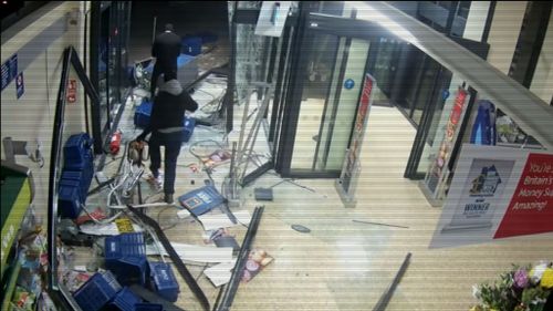 This is the moment brazen thieves smash a stolen car through an Aldi store. 