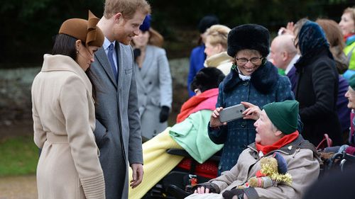 Markle and Prince Harry speak to members of the public. (AAP)