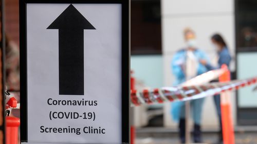 MELBOURNE, AUSTRALIA - MARCH 11: A sign directing people to the COVID-19 screening area is posted outside the Royal Melbourne Hospital on March 11, 2020 in Melbourne, Australia. Seven coronavirus screening clinics are now open in Victoria to help avoid the further spread of COVID-19. 18 people in Victoria have now been diagnosed with the virus, with the Australian total of confirmed cases now at 100.(Photo by Luis Ascui/Getty Images)