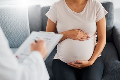 Shot of a pregnant young woman at the doctor