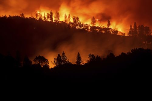 The Camp Fire burns along a ridgetop near Big Bend, California, on Saturday night LA time.