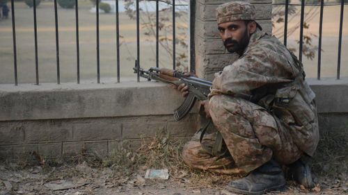 Pakistani soldier takes position near the site of an attack by Taliban gunmen on a school in the northwestern city of Peshawar, Pakistan. (Getty)