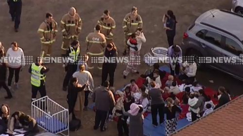 Staff and children moved to the car park across the road from the child care centre while safety checks are performed. (9NEWS)