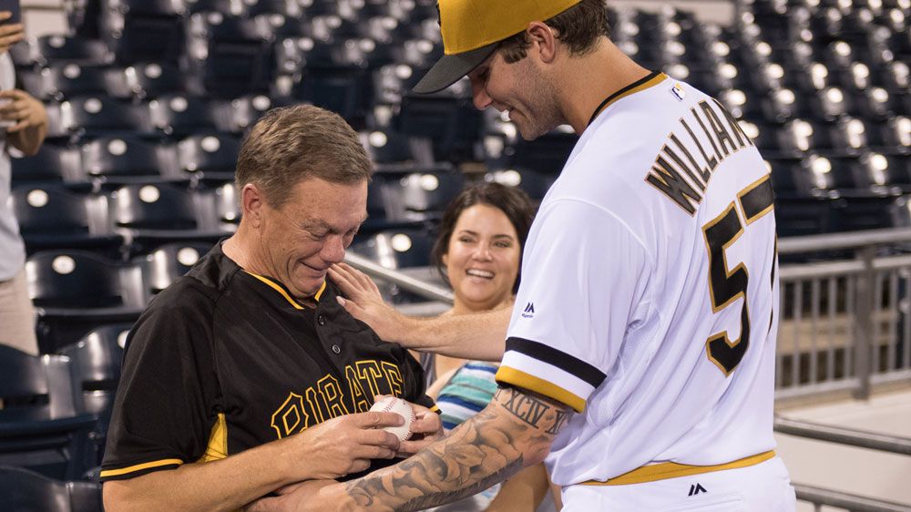 Trevor Williams (right) hands over the game ball to his dad (Getty)