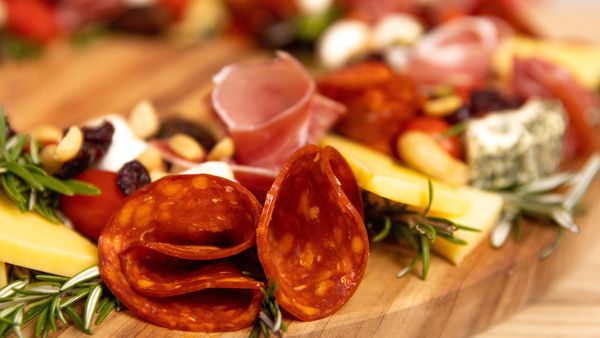 Tricks to make a cheeseboard stand out include the way you lay the cold cuts 