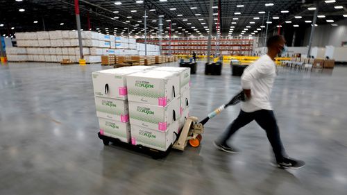 Boxes containing the Moderna COVID-19 vaccine are moved to the loading dock for shipping at the McKesson distribution centre in Olive Branch, Mississippi.