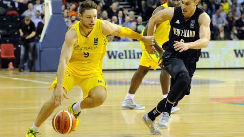 Australia's Matthew Dellavedova, left, runs around New Zealand's Jarrod Kenny.