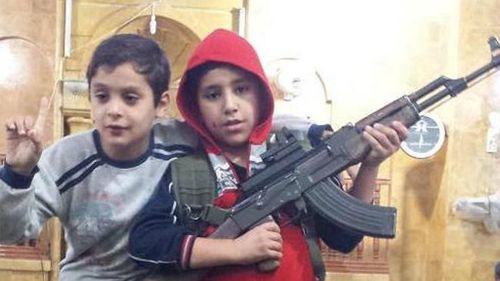 Abdullatif tweeted this image of children posing with an assault rifle. (Supplied)