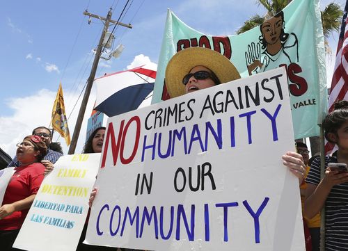 Stefanie Herweck stands with other protesters in front of the US Customs and Border Protection's Rio Grande Valley Sector's Centralized Processing Center. Picture: AAP