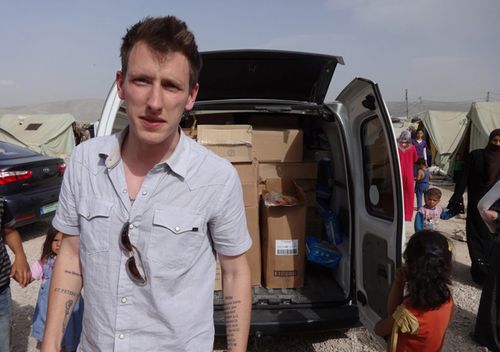 Undated photo shows Peter Kassig standing in front of a truck filled with supplies for Syrian refugees. 