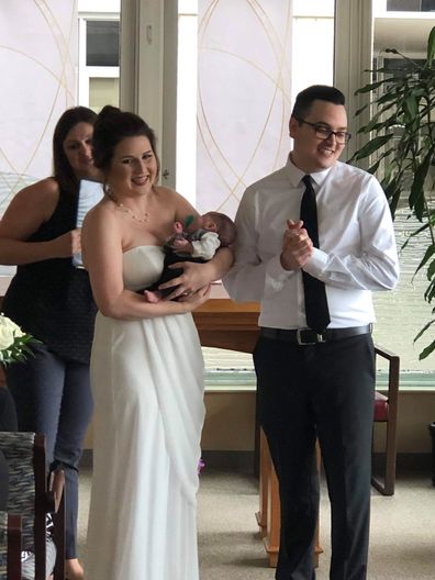 Bride carries premature baby down aisle at wedding