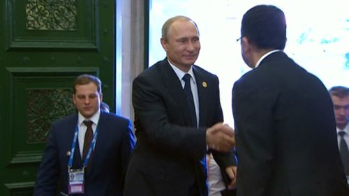 Russian president Vladimir Putin is greeted upon his arrival at Queensland's Parliament House. (9NEWS)