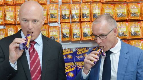 Phil Sims and Jay Weatherill sample the product today. (AAP)