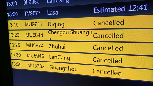 A screen displays cancelled China Eastern Airline flights at Kunming Changshui International Airport, Tuesday, March 22, 2022, in Kunming in southwest China's Yunnan province. 