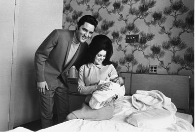 FILE - Lisa Marie Presley poses for her first picture, in the lap of her mother, Priscilla, on Feb. 5, 1968, with her father, Elvis Presley. Lisa Marie Presley  the only child of Elvis Presley and a singer herself  was hospitalized Thursday, Jan. 12, 2023, her mother said in a statement. (AP Photo/Perry Aycock, File)