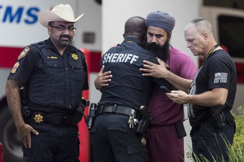 Mourners gather outside Memorial Hermann Hospital after Harris County Sheriff's Deputy Sandeep Dhaliwal was transported to the medical examiners office after was shot and killed in the line of duty. Brett Coomer/Houston Chronicle)