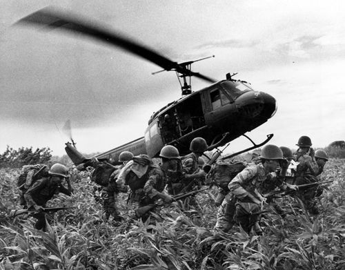 South Vietnamese Marines rush to the point where descending U.S. Army helicopter will pick them up after a sweep east of the Cambodian town of Prey-Veng during the Vietnam War. (AAP)