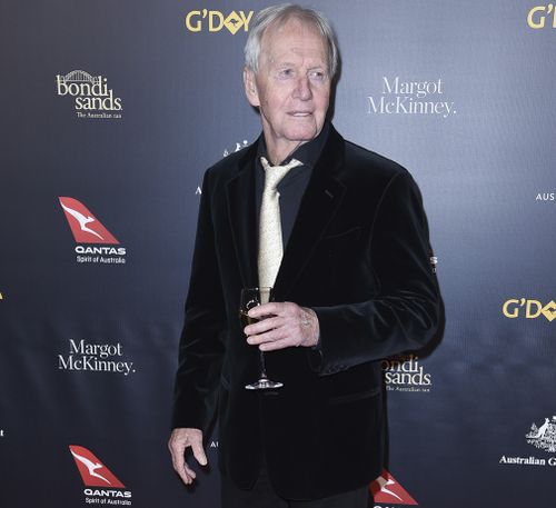 Paul Hogan on the red carpet - with white wine in hand.