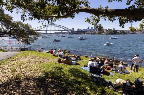 SYDNEY, AUSTRALIA - DECEMBER 31: A small group of people are seen at Mrs Macquaries Point with limited numbers during New Year's Eve celebrations on December 31, 2021 in Sydney, Australia. New Year's Eve celebrations continue to be somewhat different as some COVID-19 restrictions remain in place due to the ongoing coronavirus pandemic. (Photo by Jenny Evans/Getty Images)