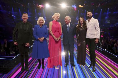 King Charles III, third from right, and Camilla, the Queen Consort, second from left, pose with the presenters of this year's Eurovision Song Contest, Scott Mills, left, Hannah Waddingham, center, Julia Sanina, second from right, and Rylan Clark, as they visit the host venue of this year's Eurovision Song Contest, the M&S Bank Arena in Liverpool, England, Wednesday, April 26, 2023 