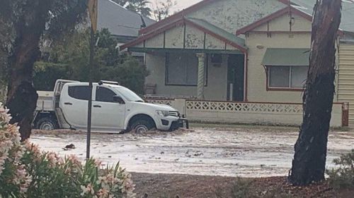 The flash flooding reached half-way up this 4WD ute's wheels.