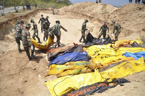 Authorities had to bury more than 150 bodies in a mass grave in the city of Palu.