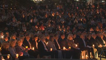 Bondi Beach has fallen silent this evening as thousands gathered for a candlelight vigil.