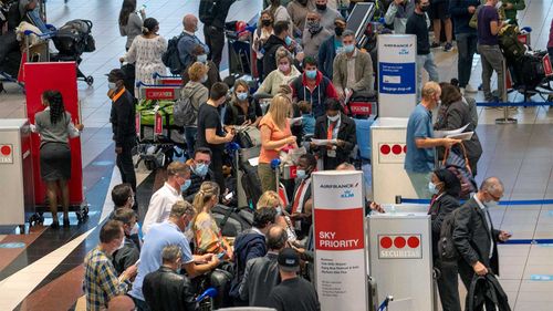 People line up to get on the Air France flight to Paris at OR Tambo International Airport in Johannesburg, South Africa.