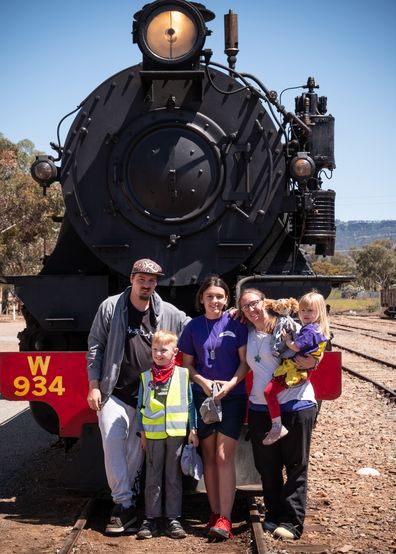 Broly Blackmore with his family in front of a steam train.