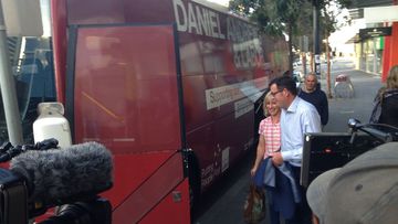 Daniel Andrews prepares to board the Labor party campaign bus with his wife Cath. (9NEWS)