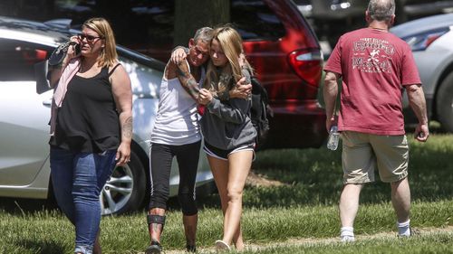 Relieved parents come to collect their children after the school shooting in Indiana. (AAP)