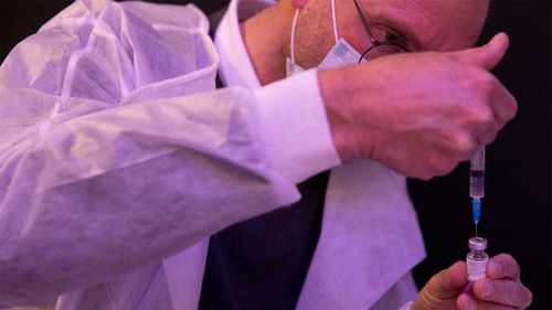 A medical professional prepares to administer a second dose of the Pfizer COVID-19 vaccine in Netanya, Israel.