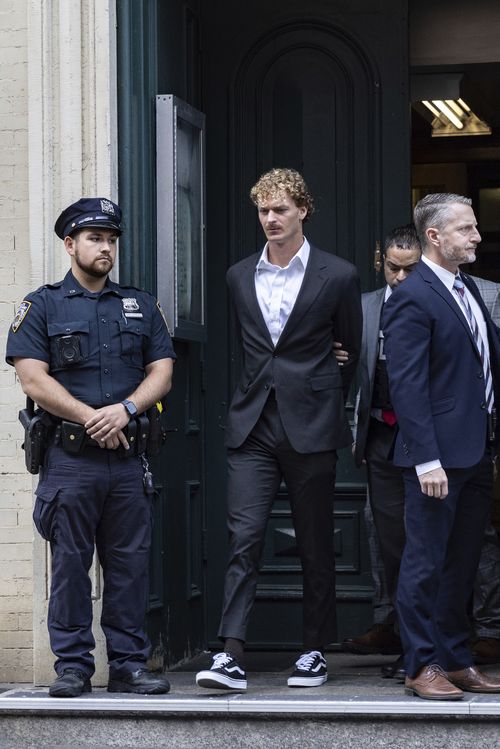 Daniel Penny, center, is walked by New York Police Department detectives detectives out of the 5th Precinct on Friday, May. 12, 2023 in New York. 