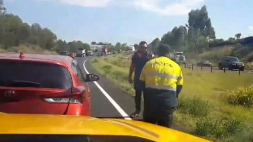 Other motorists filmed as the men clashed on the road.