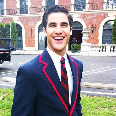 A behind-the-scenes shot of Darren Criss in costume as Blaine Anderson on Glee.