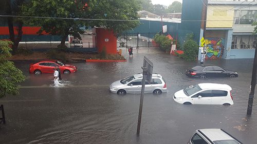Flooding on Botany Road at Waterloo left cars stuck in the middle of the street. (Supplied: Roberto Romeo)
