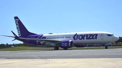 Bonza passenger jet taxis on the runway.