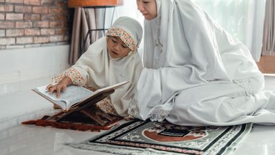 mother and kid reading quran together at home ramadan eid muslim islam