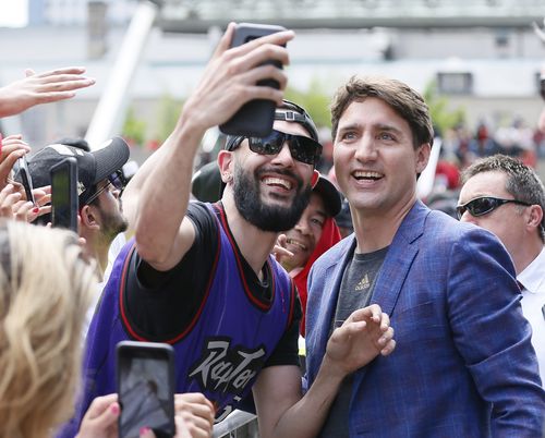 Canadian prime minister Justin Trudeau poses for a selfie with a Toronto Raptors fan. Credit: John E. Sokolowski-USA TODAY Sports.