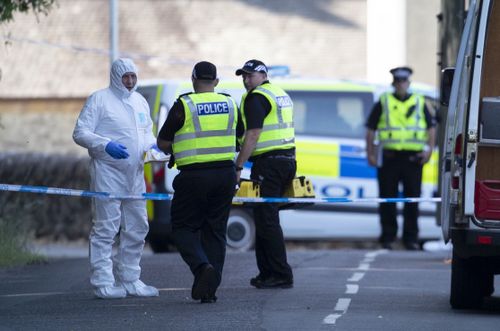 Forensic officers investigate the murder. 