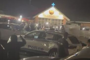 Large angry crowd outside Western Sydney church