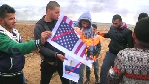 Protesters were also seen burning US flags (Supplied)
