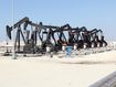 Black oil pump jacks in the desert of Bahrain.