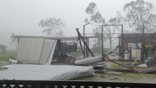 Pieces of the shed lay strewn across a Yeppoon backyard. (Supplied: Natalee Smith)     