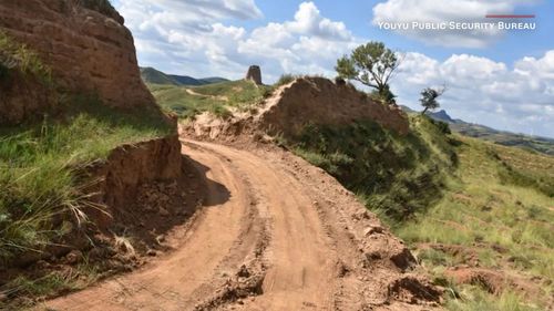 Two people have been arrested for allegedly tearing a giant hole through the Great Wall of China with an excavator.