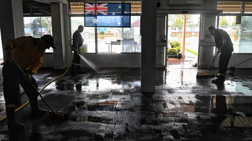 RFS pump and sweep out flood water from the Camden RSL as flooding drops.